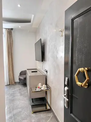 a bedroom with a large bed with two pillows on it at Daphne Suites in Rome