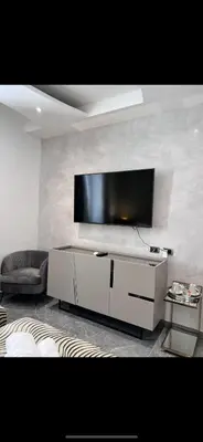 a room with a door and a tv and a couch at Daphne Suites in Rome