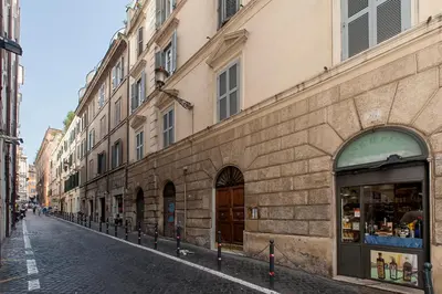 a bedroom with a large white bed with a couch at Daphne Suites in Rome