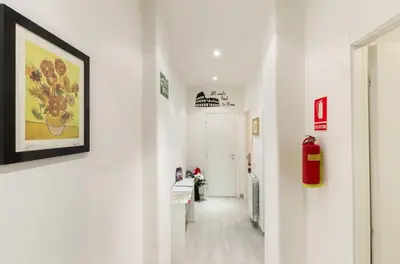 a hallway with white walls and a painting on the wall at Vacanze romane holidays in Rome