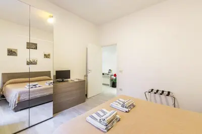 a bedroom with a bed and a table with towels at Vacanze romane holidays in Rome