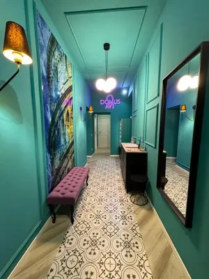 a bathroom with a pink bench and a sink and a mirror at Domus Avi Vaticano in Rome