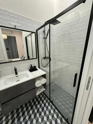 a bathroom with a shower and a sink and a mirror at Domus Avi Vaticano in Rome