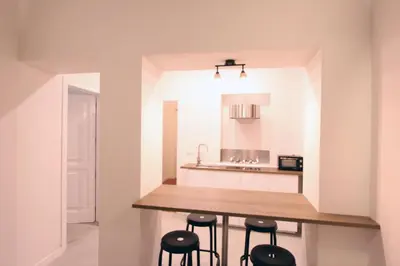 a kitchen with a wooden counter and stools at Monte Giordano Flats in Rome