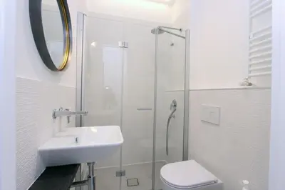 a bathroom with a sink and a toilet and a shower at Monte Giordano Flats in Rome