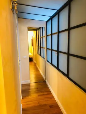 an empty hallway with a blue ceiling and windows at Luxury Apartment Frattina 34 Anelli in Rome