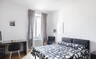 a bedroom with a bed and a desk and a computer at Urbanflat Roma in Rome
