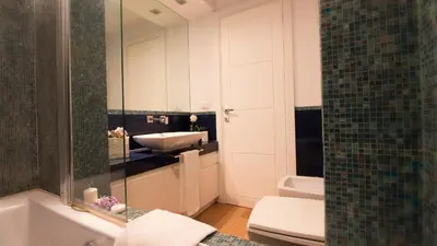 a bathroom with a sink and a tub and a toilet at Urbanflat Roma in Rome