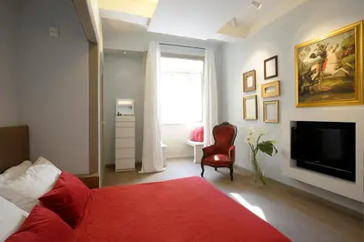 a hallway with a kitchen and a living room at Raffaello Charmsuite in Rome