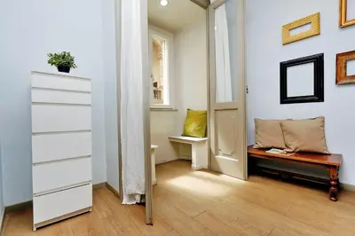 a hallway with a dresser and a bench in a room at Raffaello Charmsuite in Rome