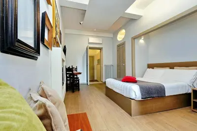 a bedroom with a large bed in a room at Raffaello Charmsuite in Rome