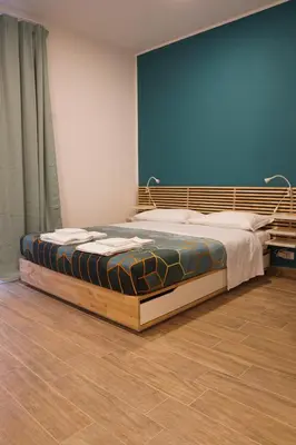 a large bed in a room with a blue wall at Roma Trasteverina in Rome