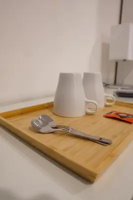 a wooden cutting board with a spoon and fork on it at Roma Trasteverina in Rome