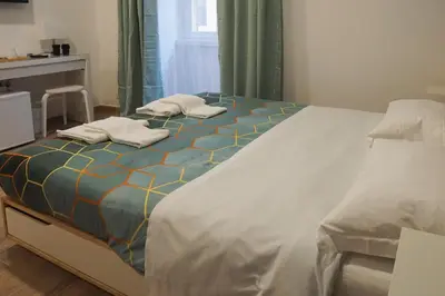 a large bed in a bedroom with green curtains at Roma Trasteverina in Rome