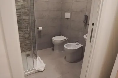 a bathroom with a toilet and a shower and a sink at Roma Trasteverina in Rome