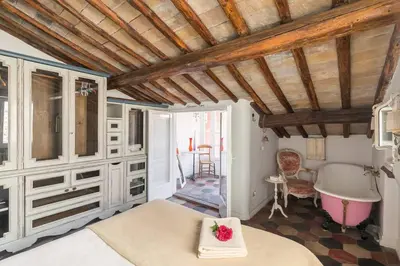 a bedroom with a bed and a bath tub at Scala Lovely Terrace Apartment in Rome