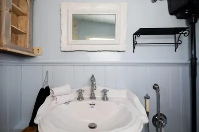 a bathroom with a white sink and a mirror at Scala Lovely Terrace Apartment in Rome