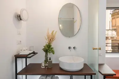 a bathroom with a sink and a mirror on the wall at Maison Ottavia in Rome