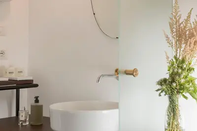 a bathroom with a white tub and a sink at Maison Ottavia in Rome