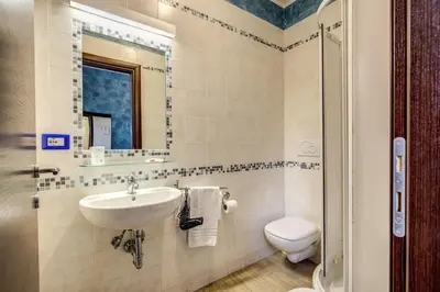 a bathroom with a sink and a toilet at Buonarroti Suite in Rome