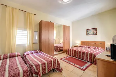 a hotel room with two beds and a mirror at Buonarroti Suite in Rome