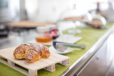 a couple of croissants on a cutting board on a counter at Wrooms Guest House in Rome