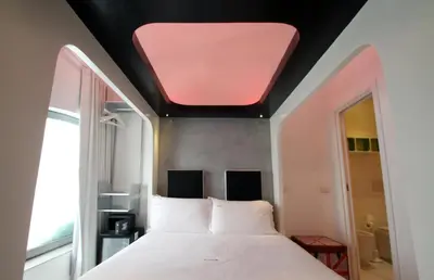 a bedroom with a large bed with a red ceiling at Wrooms Guest House in Rome