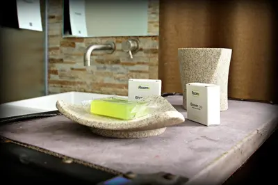 a bathroom counter with a sink with two boxes on it at Wrooms Guest House in Rome