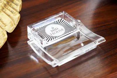 a clear box with a not words sticker on a table at Mid House in Rome