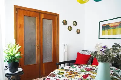 a bedroom with a bed and a wooden door at Mid House in Rome