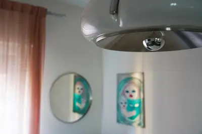 a mirror on a wall with two pictures on it at Mid House in Rome
