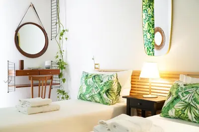 a room with two beds and a table with a mirror at Mid House in Rome