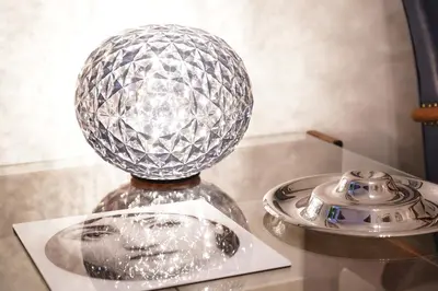 a glass ball on top of a table with a phone at Mid House in Rome