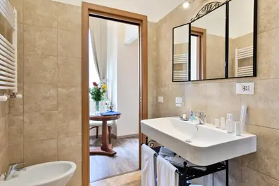 a bathroom with a sink and a mirror at Vatican Domus Luxury Rooms in Rome