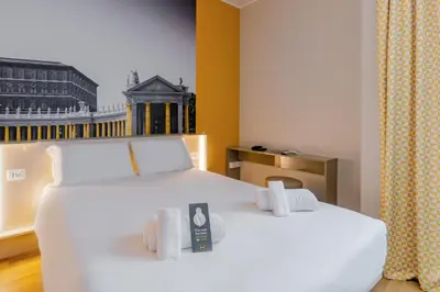 a hotel room with a white bed and a window at B&B Hotel Roma Pietralata Tiburtina in Rome