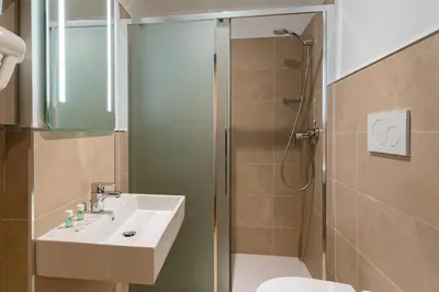 a bathroom with a sink and a shower at B&B Hotel Roma Pietralata Tiburtina in Rome