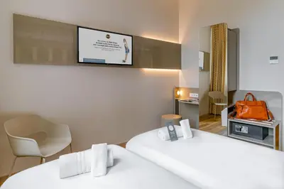 a hotel room with two beds and a flat screen tv at B&B Hotel Roma Pietralata Tiburtina in Rome