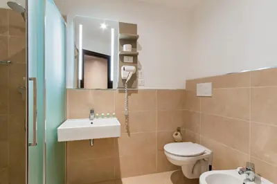 a bathroom with a toilet and a sink and a mirror at B&B Hotel Roma Pietralata Tiburtina in Rome