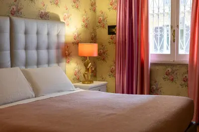 a bedroom with a bed and a window and a lamp at T-House Fontana di Trevi in Rome