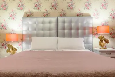 a bedroom with a large bed with a white bedspread at T-House Fontana di Trevi in Rome