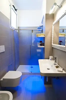 a bathroom with a toilet and a sink and a shower at Domus Fontis in Rome