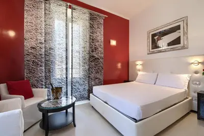 a bedroom with a bed and a couch and a table at Alloggio per uso turistico D'Ambrosio Antonella Gli Scipioni 53 in Rome