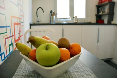 a bowl of fruit on a table in a kitchen at Alloggio per uso turistico D'Ambrosio Antonella Gli Scipioni 53 in Rome