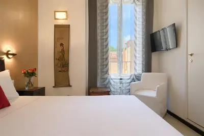 a bedroom with a white bed and a window at Alloggio per uso turistico D'Ambrosio Antonella Gli Scipioni 53 in Rome