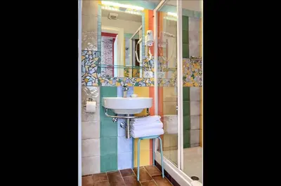 a bathroom with a sink and a mirror at Alloggio per uso turistico D'Ambrosio Antonella Gli Scipioni 53 in Rome