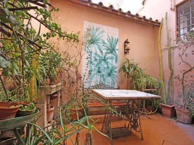 an outdoor patio with a table and potted plants at Terrace Apartment - Heart of Trastevere in Rome