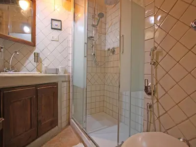 a bathroom with a shower and a toilet and a sink at Terrace Apartment - Heart of Trastevere in Rome