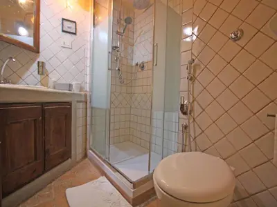 a bathroom with a shower with a toilet and a sink at Terrace Apartment - Heart of Trastevere in Rome