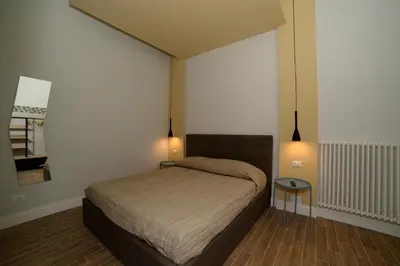 a bedroom with a bed with two lights on it at La dolce casa di Giulia in Rome