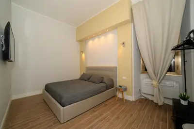 a small bedroom with a bed and a window at La dolce casa di Giulia in Rome